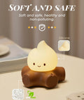 Chibi Campfire Night Light With White Noise Portable Rechargeable Cozy Camping Glow for Kids Rooms Sleep Aid on table.