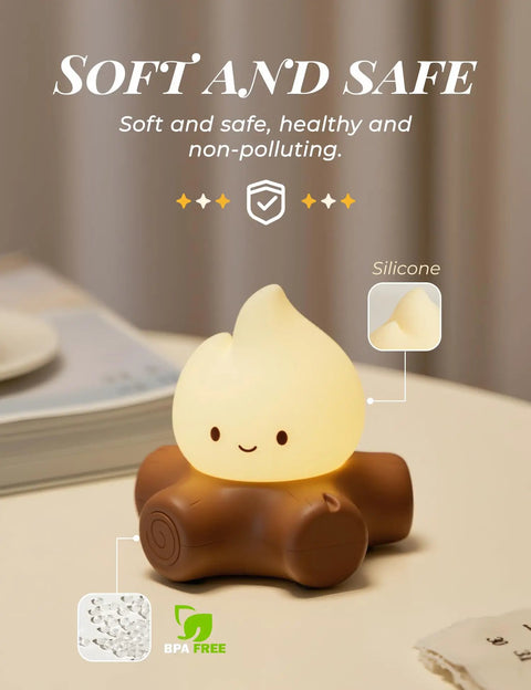 Chibi Campfire Night Light With White Noise Portable Rechargeable Cozy Camping Glow for Kids Rooms Sleep Aid on table.