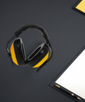 Adjustable Yellow Noise Blocking Ear Defenders For Shooting And Industrial Jobs With Slap Up Soundproof Earmuffs on a desk.