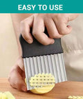 Large stainless steel multi-blade fry cutter with a black handle cutting a potato