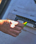 Hand using Magnetic Fishing Lure And Tool Organizer With Patented Design, Heavy Duty Neodymium Magnets For Secure Lure Changes, Fast Access