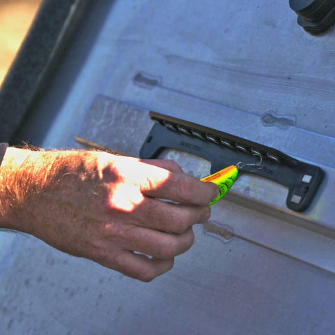 Hand using Magnetic Fishing Lure And Tool Organizer With Patented Design, Heavy Duty Neodymium Magnets For Secure Lure Changes, Fast Access