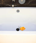 Fish Bathtub Drain Stopper with Chain Rubber for Shower Drains in a modern bathtub with an orange fish design.