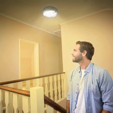 Man looking at Cordless Battery Operated Motion Sensor Light Indoor 80 LED Closet Ceiling Lamp With 400LM 3200K Warm White