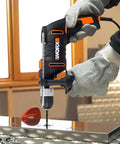 Heavy Duty 600 Watt Impact Drill Driver With 13 Mm Keyless Chuck And Variable Speed Control in use, drilling metal with gloves.