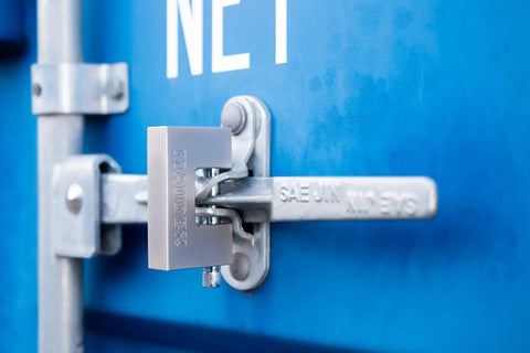 MDP 70 Heavy Duty Padlock With 0.59 Inch Shackle Clearance And 0.47 Inch Thick Bolt Nickel Plated Finish Anti Pick Anti Drill Cylinder Perfect Lock For Storage Units With Ten Keys securing a blue container door.
