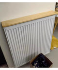 Custom Size Wooden Radiator Shelf Cover Wall Mounted Hidden Storage Panel With Heavy Duty Steel Brackets For Bedroom Office Garage. Top view of a wooden shelf over a radiator.