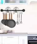 31.5 Inch Wall Mounted Pot Rack With Detachable Pan Lid Organizer And 14 Hooks Heavy Duty Iron In Matte Black For Kitchen Utensils Pots Pans And Lids Storage Keeps Your Kitchen Neat And On Point shown in a kitchen setup with hanging utensils and pans.