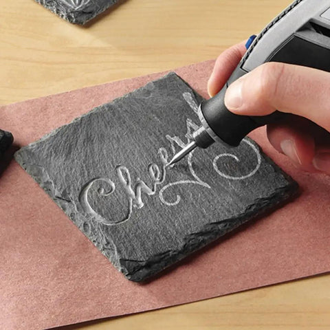 Hand using 8 Piece Glass And Stone Accessory Micro Kit for carving on slate