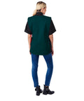 Rugged Cobbler Apron With Two Deep Pockets Cut From Smooth Poly Cotton Twill Featuring Adjustable Side Ties And Reinforced Seams worn by a woman from the back.