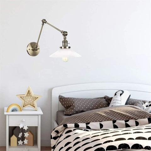 Wall Sconce Lights Indoor Bedroom Hallway Swing Arm Lamps with Switch,Adjustable Metal,Clear Glass Shade,Hardwired Industrial Lamp for,and Living Room, mounted over a bed.