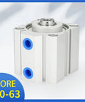 Front view of a compact pneumatic double-acting cylinder with white aluminum body and blue port holes.