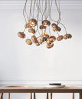 Handmade Solid Wood 19 Light Pendant Chandelier With Drop Dead Gorgeous Art Flower Petals And Smart Led Tech Generating Heavy Ambient Vibes For Your Interior Setup hanging above a wooden table.