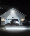 150W Outdoor LED Flood Light With Plug, 18000lm illuminating a driveway at night, showing IP66 waterproof capability