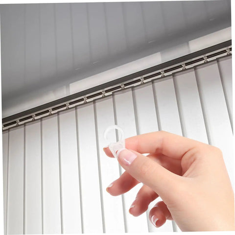 Hand holding clear hook from 40 Pack Plastic Curtain Hooks for Shower and Window Drapery, Silent Glide and Flexible Compatibility, Small Clip Hangers