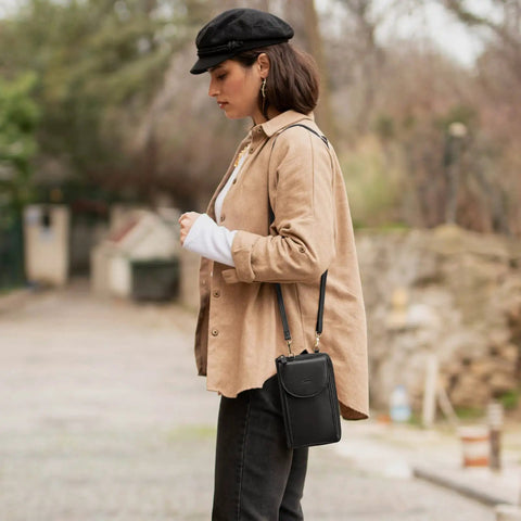 Woman wearing small crossbody bag for women with RFID blocking wallet and card slots, phone pouch, secure zippered compartments.