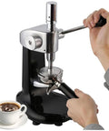 Top Shelf 58 Mm Coffee Tamper With Ergonomic Grip And Solid Steel Base For Zero Sweat Espresso Compaction And Barista Grade Pulls Straight From Your Kitchen Counter in use with black espresso machine.