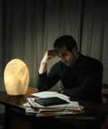 Man reading by Natural Calcite Stone Lamp With 15 Pound Solid Crystal Handcrafted One Of A Kind Table Lamp With Warm Dimmable Glow