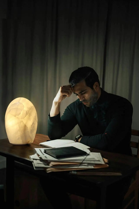 Man reading by Natural Calcite Stone Lamp With 15 Pound Solid Crystal Handcrafted One Of A Kind Table Lamp With Warm Dimmable Glow
