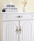 White cabinet with Dope Round Cabinet Knobs 10 Pack 1.25 Inch Brushed Gunmetal Drawer Pulls in decorative setting