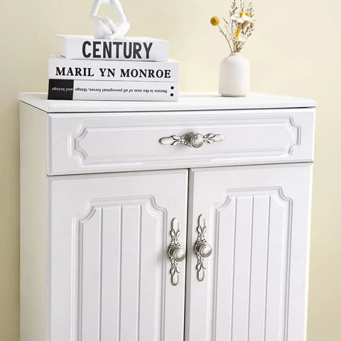 White cabinet with Dope Round Cabinet Knobs 10 Pack 1.25 Inch Brushed Gunmetal Drawer Pulls in decorative setting