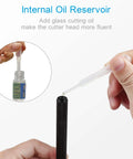 Glass cutter pencil-style with internal oil reservoir; black knurled body and clear oil-feed tube beside oil bottle.