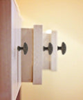 Side view of vintage zinc alloy drawer pull ring and cabinet handle set on wooden drawer with retro vibe.