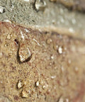 Close-up of water droplets on stone treated with One And A Half Gallon Clear Brick Sealer For Brick Stone Concrete And Masonry No Nonsense