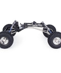 Side view of High Clearance LCG RC Crawler Chassis Kit with carbon fiber rails, portal axles, forward gearbox, and adjustable shocks for 1x10 scale.