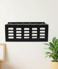 Heavy Duty Wall Mount Caulk Tube Holder Rack Holds Eleven Adhesive Cartridges Upright Locks Secure on wall with plant nearby.