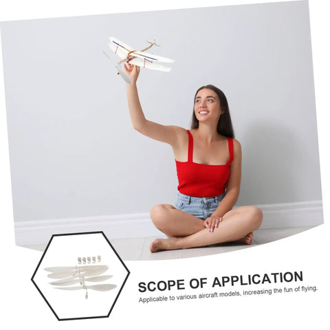 Smiling woman holding model plane with 5 Piece RC Airplane Propeller Blades Rad High Performance Rubber Band Powered Gear displayed