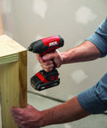 Person using the 4 Tool Power Kit With 20V Cordless Drill Driver Impact Driver Reciprocating Saw And LED Spotlight Includes Two 2Ah Batteries And Charger For Home DIY Projects to assemble wooden furniture.