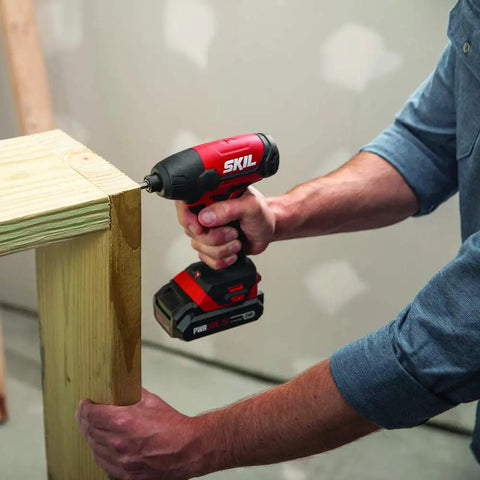 Person using the 4 Tool Power Kit With 20V Cordless Drill Driver Impact Driver Reciprocating Saw And LED Spotlight Includes Two 2Ah Batteries And Charger For Home DIY Projects to assemble wooden furniture.