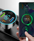 Straight Up Fast Four Port Car Charger Featuring Digital Voltmeter Pd Qc3.0 Usb C Cigarette Lighter Plug Zero Fuss Setup For Iphone Samsung And Android Riders charging a smartphone with visible LED display.