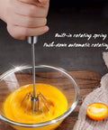 Stainless Steel Hand Push Rotary Whisk Blender Semi Automatic Kitchen Tool For Beating Eggs, Whipping Milk, Frothing Cream And Stirring, 12 Inch Durable Mixer Whisk Rod For Quick Pro Results in use, whisking eggs in a glass bowl
