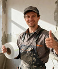 Heavy Duty Self Adhesive Fiberglass Mesh Drywall Joint Tape 1.97 Inch By 180 Feet For Wall Crack Repairs Seam Patches And Spackle Projects Built Tough For Long Lasting Smooth Walls, worker holding roll