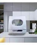 Compact Kitchen Workhorse Smart Countertop Dishwasher Automatic Tabletop Cleaner visible on a kitchen counter with plates inside.