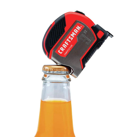 9 Foot Tape Measure With Bottle Opener, Small Magnetic Measuring Tool With Rubber Overmold Grip opening a bottle.