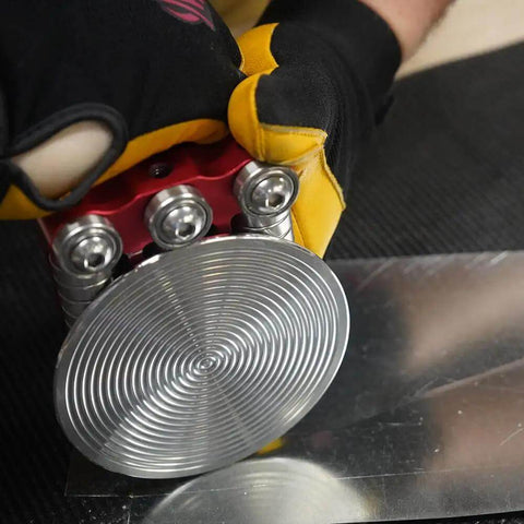 Worker using One Station Disc Bender For Sheet Metal With Large Disc Delivers Five Sixteenths To One And Three Quarters Inch Bends Curved