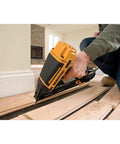 Pro Gear 15 Gauge Pneumatic Angle Finish Nailer With Dial Depth Control used on wooden flooring, showing application and precision.