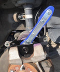 Blue G-PLUS 360° brake caliper press tool with steel plates installed on a car front brake caliper