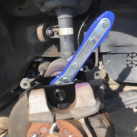Blue G-PLUS 360° brake caliper press tool with steel plates installed on a car front brake caliper