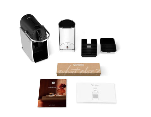 Pixie EN127S One Button Capsule Espresso Machine with accessories and manuals displayed on a white surface