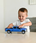 Child playing with Realistic Ford Gooseneck Truck Toy And Trailer Hitch 1 To 20 Scale Farm Toy Set For Kids And Collectors