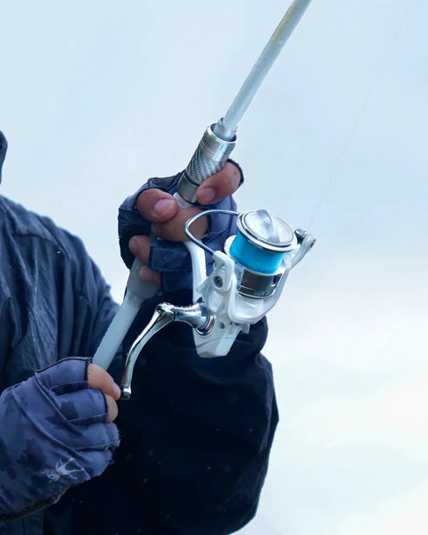 Angler gripping Telescopic Fishing Rod And Reel Combo with Bag, Carbon Fiber 30 Ton Rod, 6 Lb Drag, Ceramic Guides, blue reel visible.