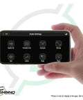 Hand holding smartphone with audio settings for Bluetooth DSP Car Audio Processor With Four Output Channels Full Digital Signal Processing Smartphone Control Built In Voltmeter And Remote Relay For Aftermarket And Factory Radios