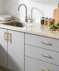 Brushed Gold Cabinet Pulls 5 Pack Three And Three Quarters Inch Hole Center Kitchen Cabinet Handles installed on grey cabinets