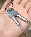 Two Piece Mini Pocket Screwdriver Set With Steel Phillips And Slotted Heads Portable Key Ring Repair Tool in hand