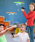 Kids playing with Light Up Flying Helicopters Set Of 2 With LED Lights And Handheld Launcher, soaring over eight feet indoors