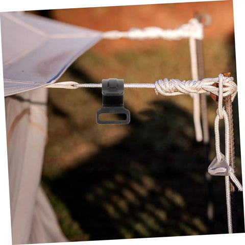 Installed 10 Pack Plastic Tent Pole Hooks For Glamping And Camping Gear Hanger on a rope, close-up in outdoor setting.